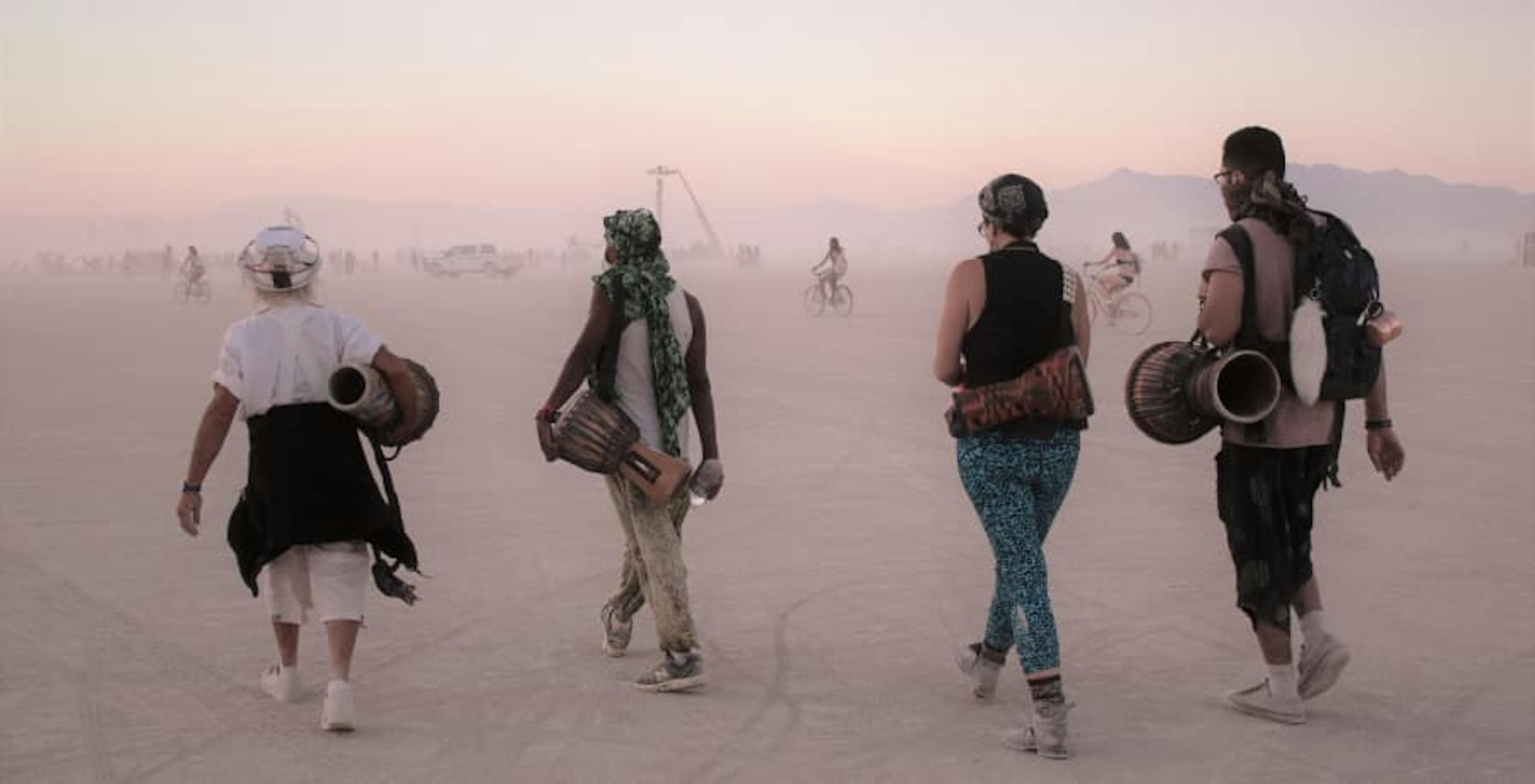 people walking to burning man