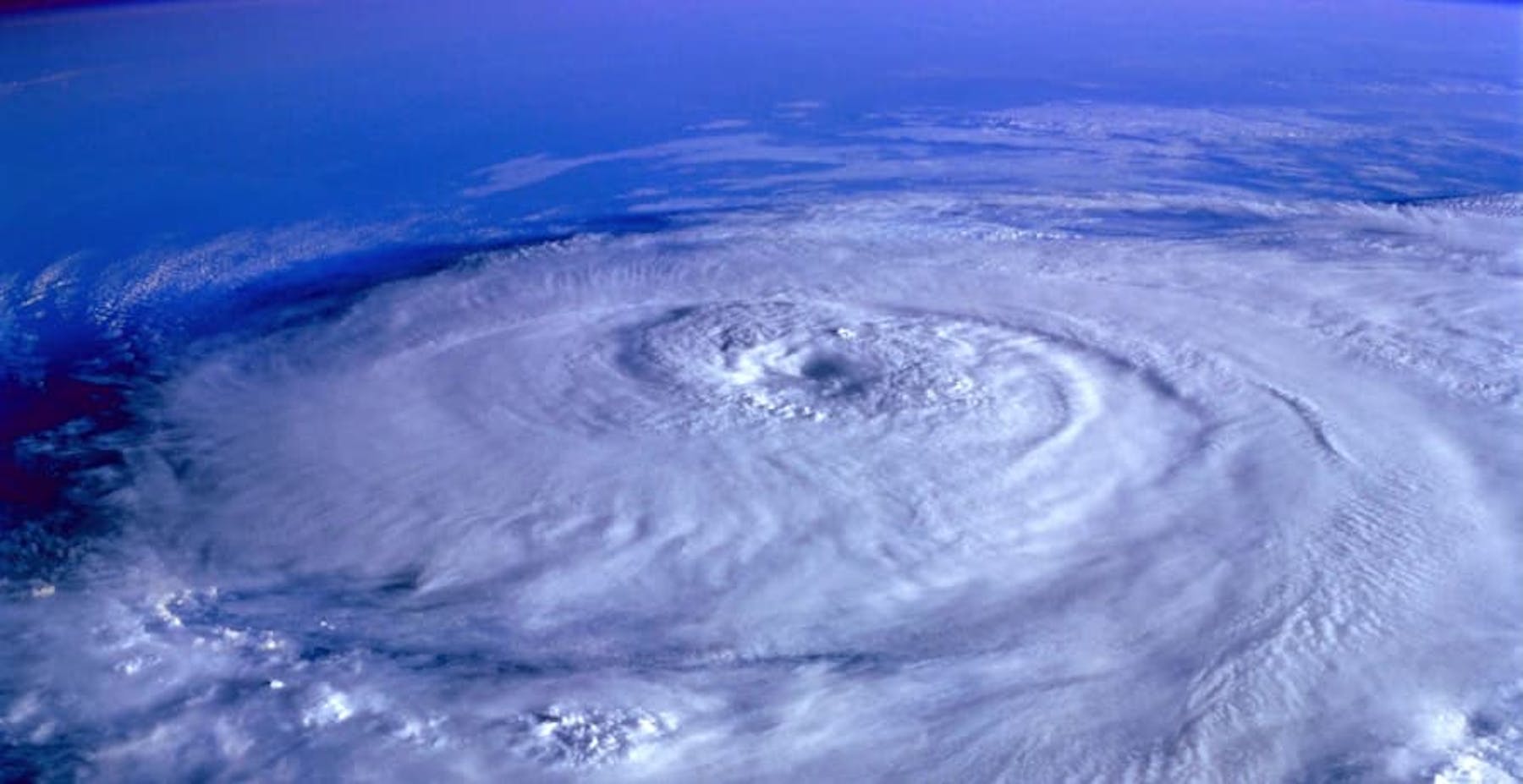 view of earth from space showing a large storm cell over the ocean