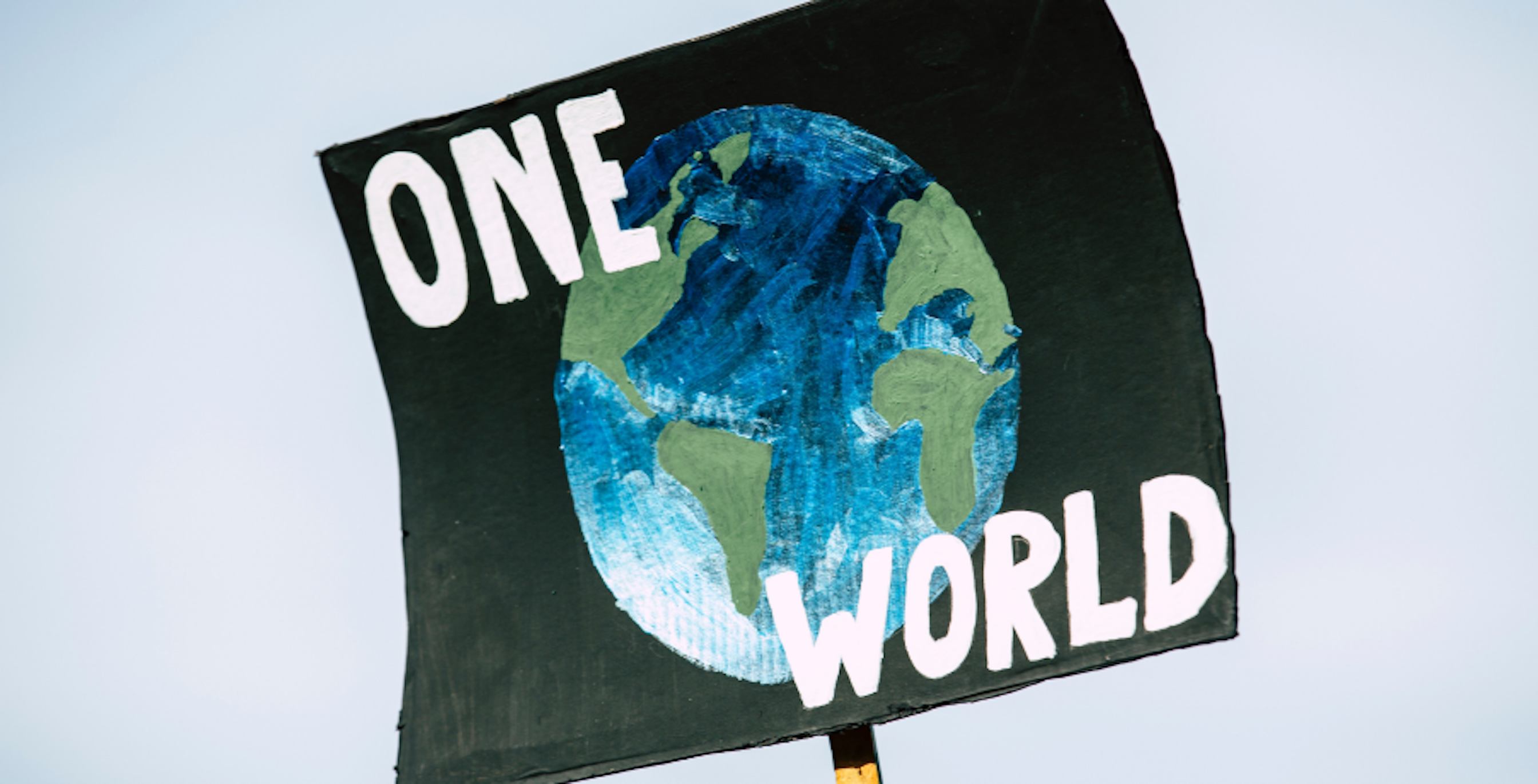 poster with earth that says, "one world"