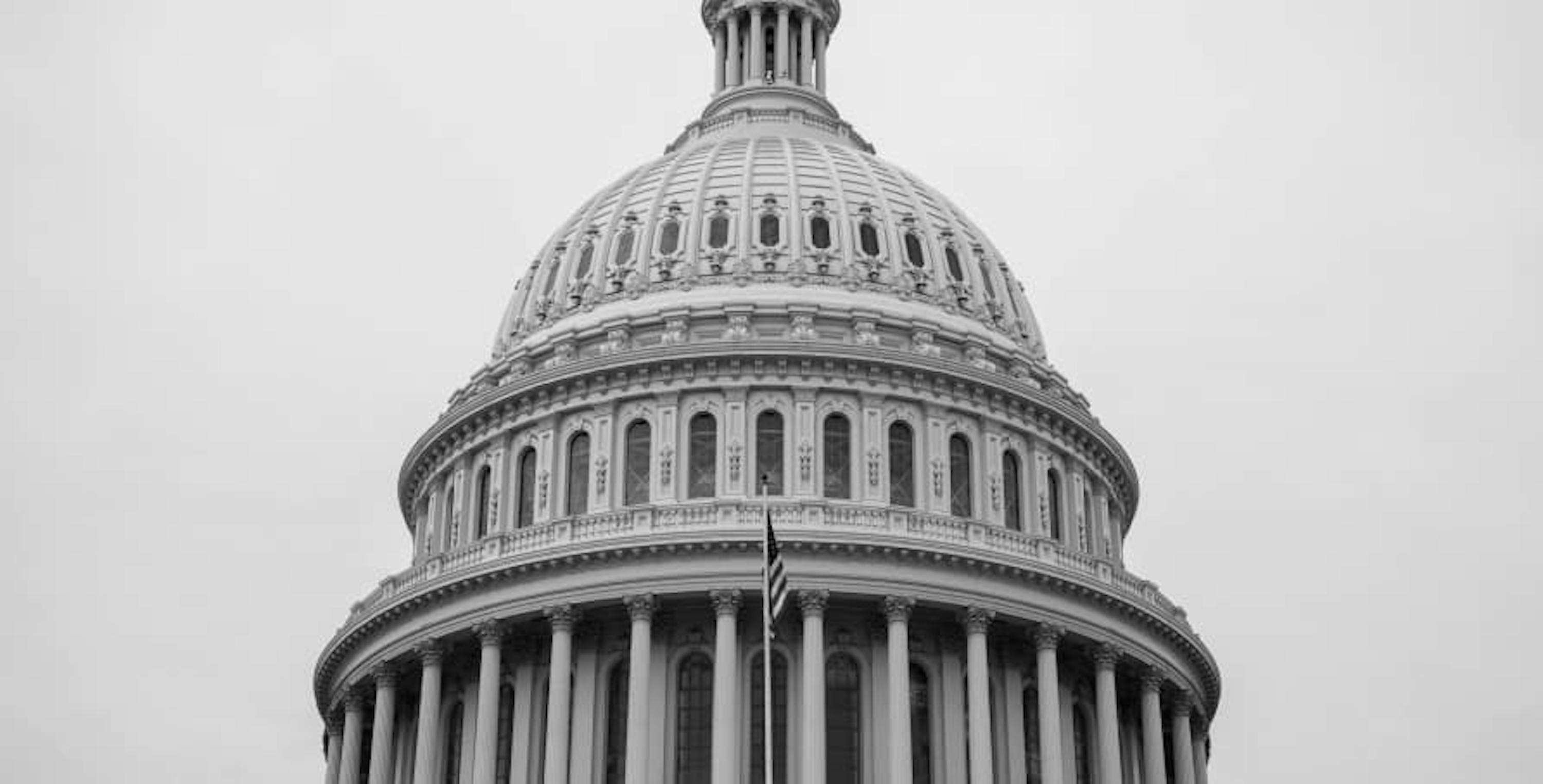 top of capitol building black and white photo