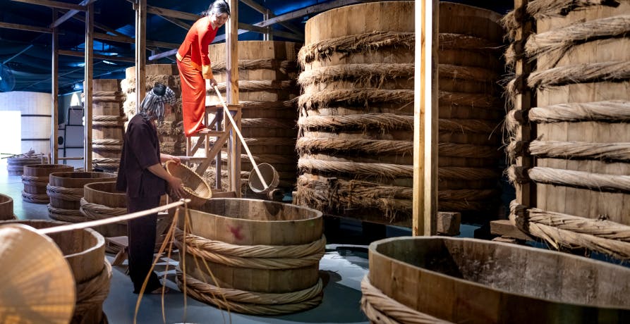 alcohol producer working inside factory