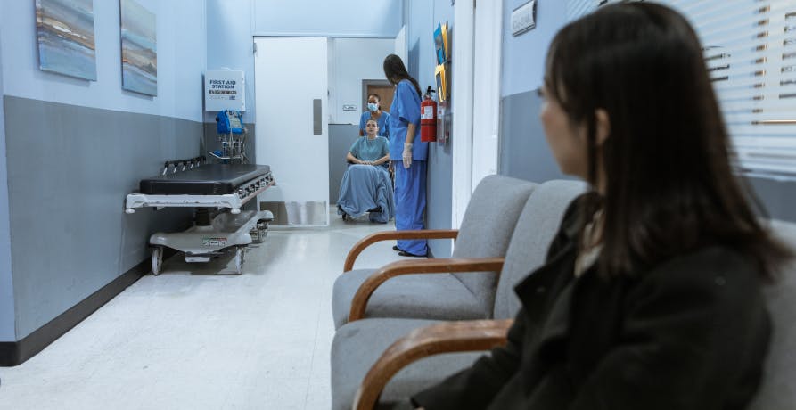 woman waiting in hospital corridor