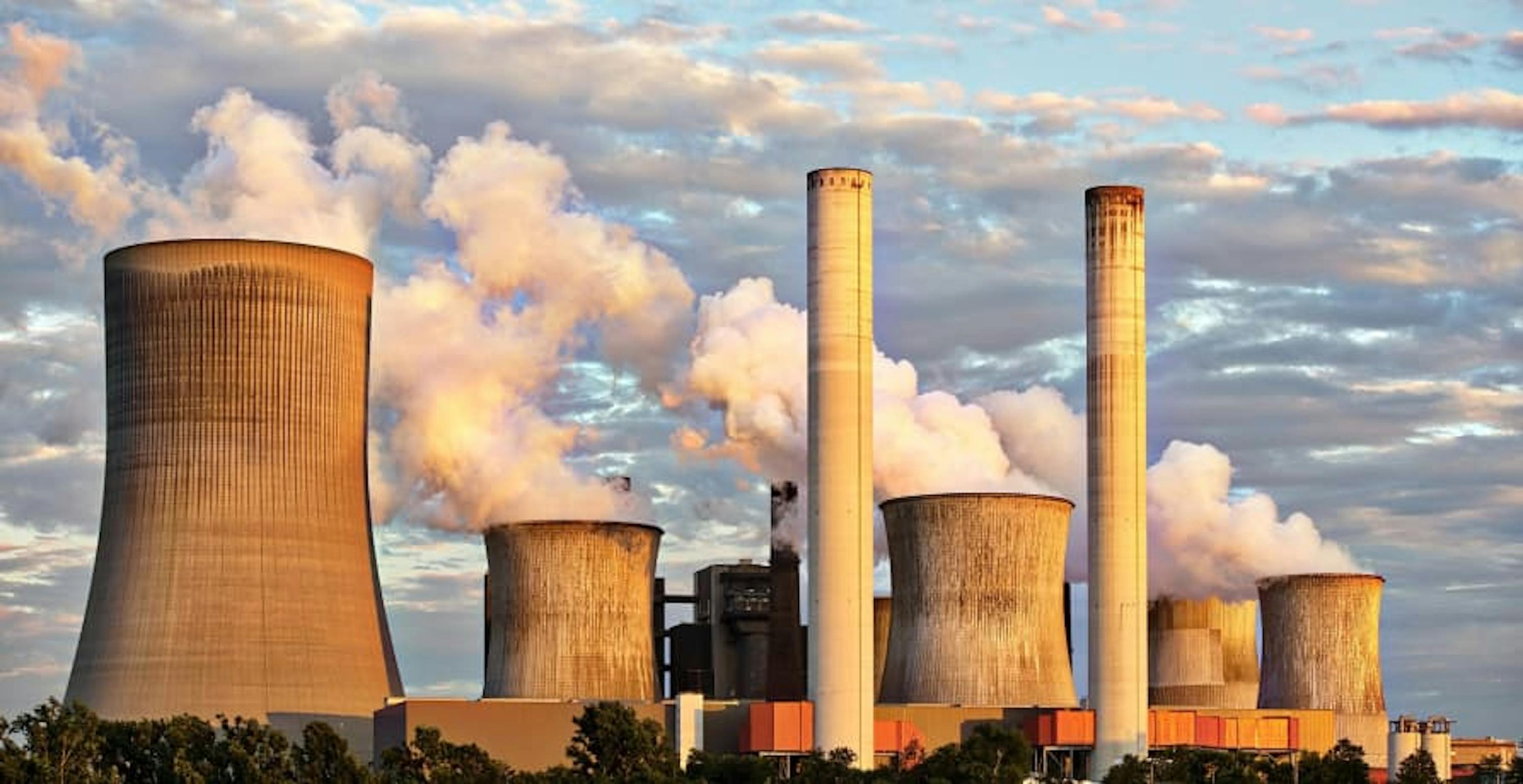 large power plant releasing emissions into the air