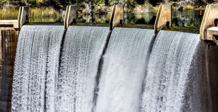 water flowing through large dam