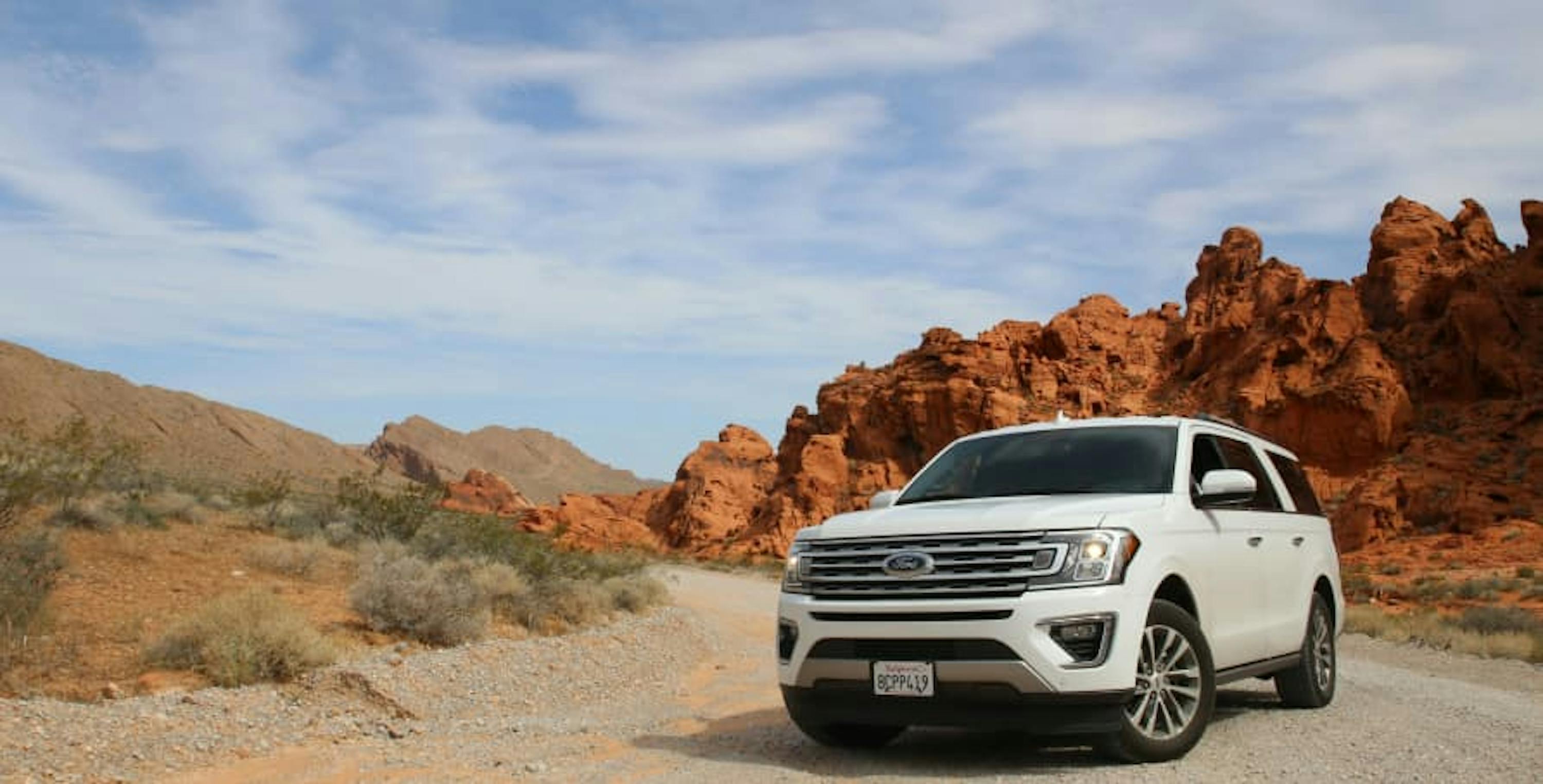 white SUV in desert with red rocks