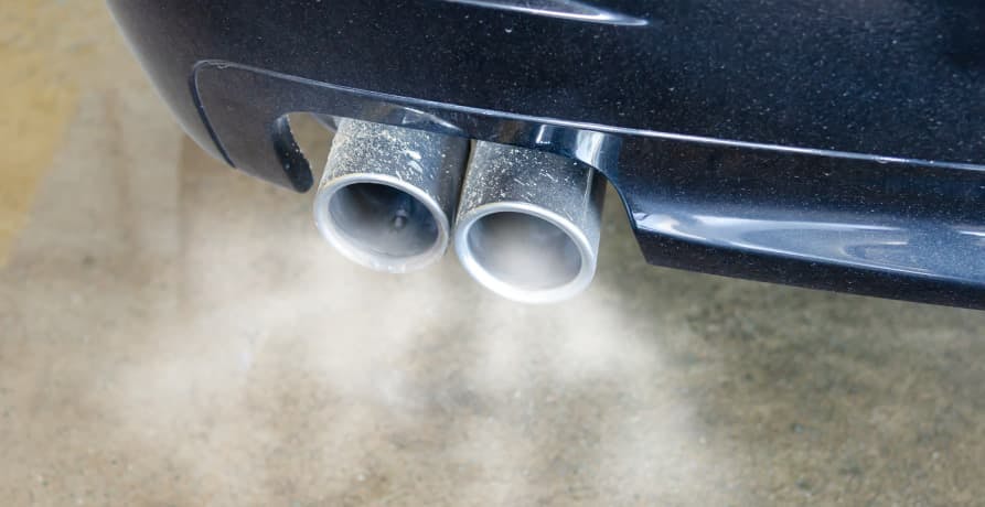 car releasing exhaust fumes