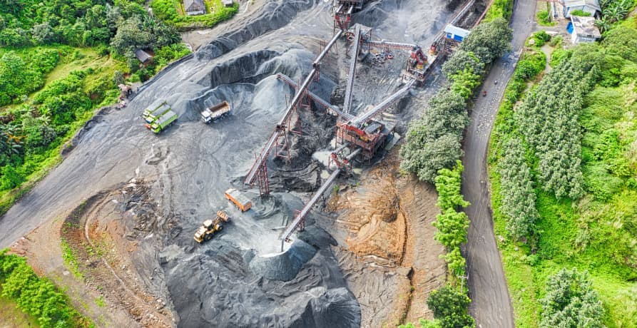 large mine surrounded by forest 