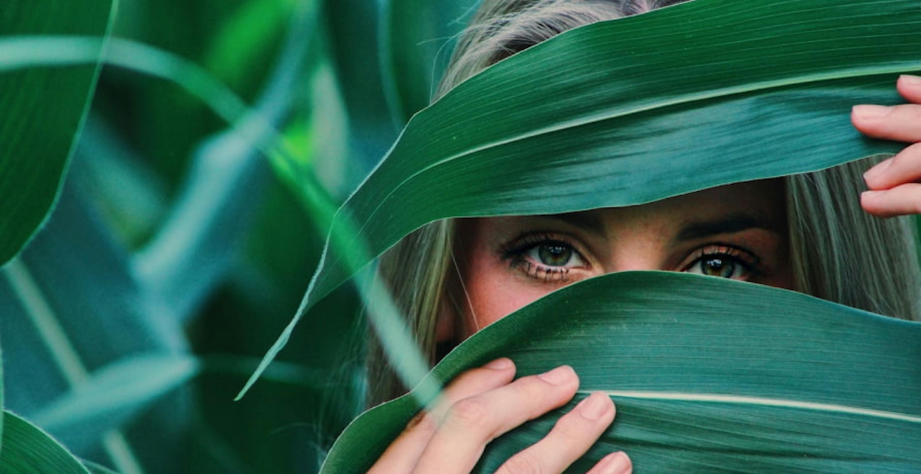 woman hidden by leaves