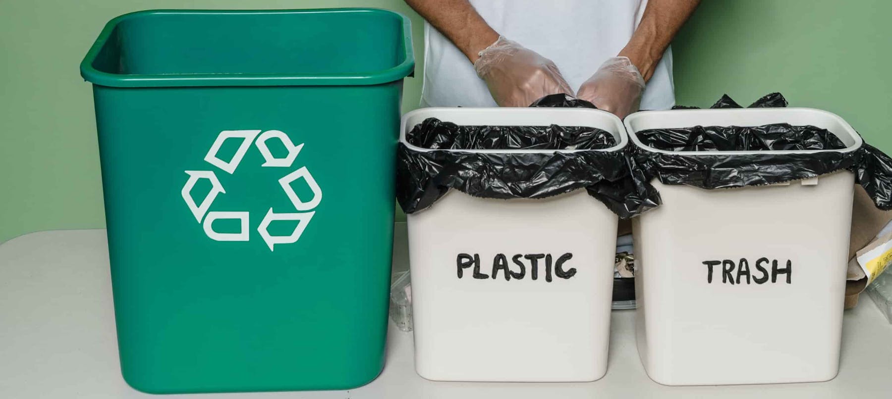 Green plastic trash bin