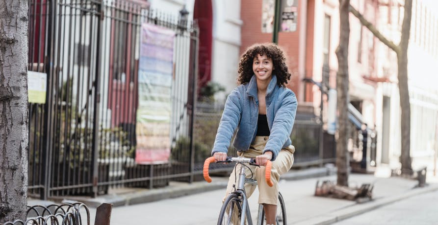 woman on bike cycling in city