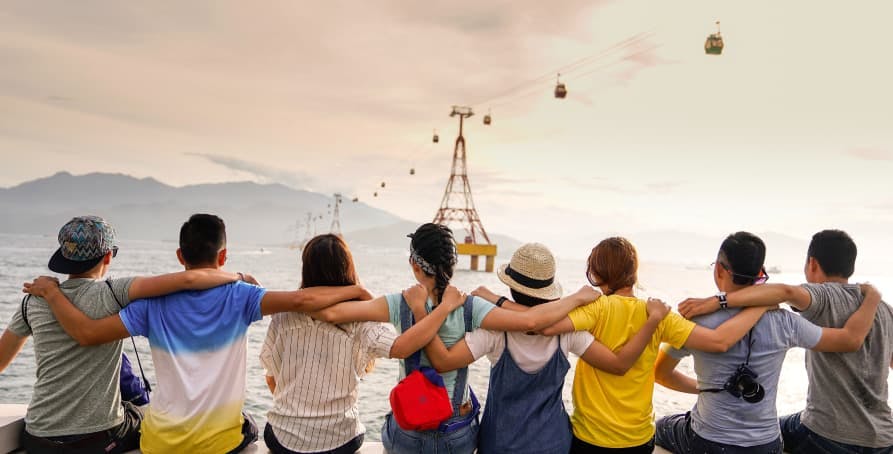 people arm and arm sitting looking over mountain view