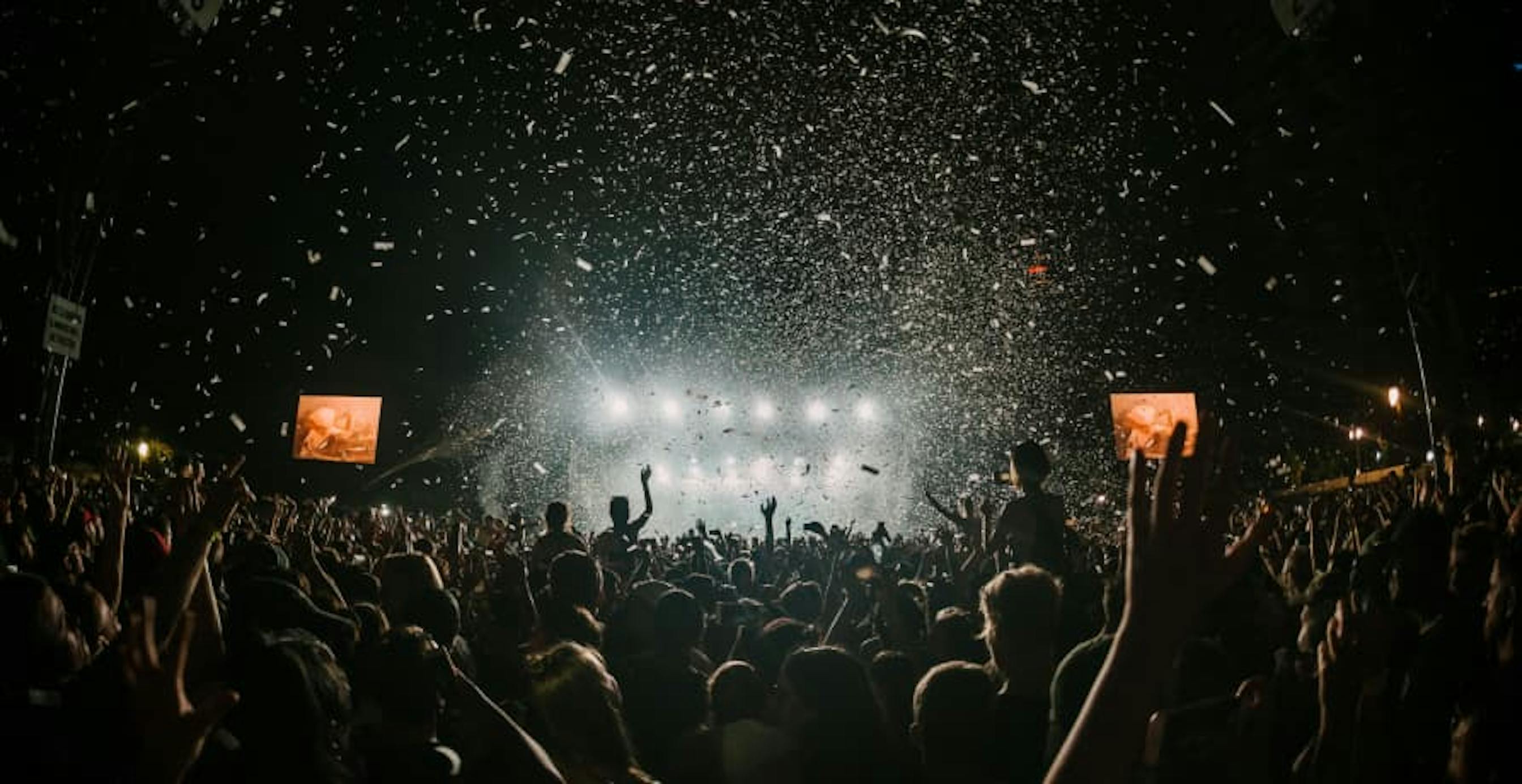 indoor crowd with confetti at night