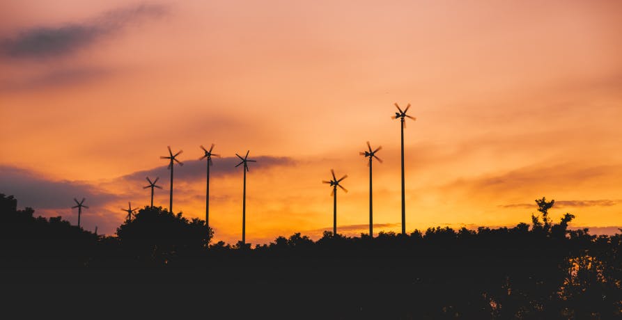 wind turbines in orange sunset
