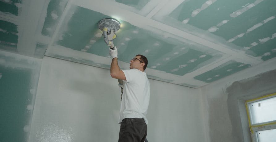 man installing light fitting