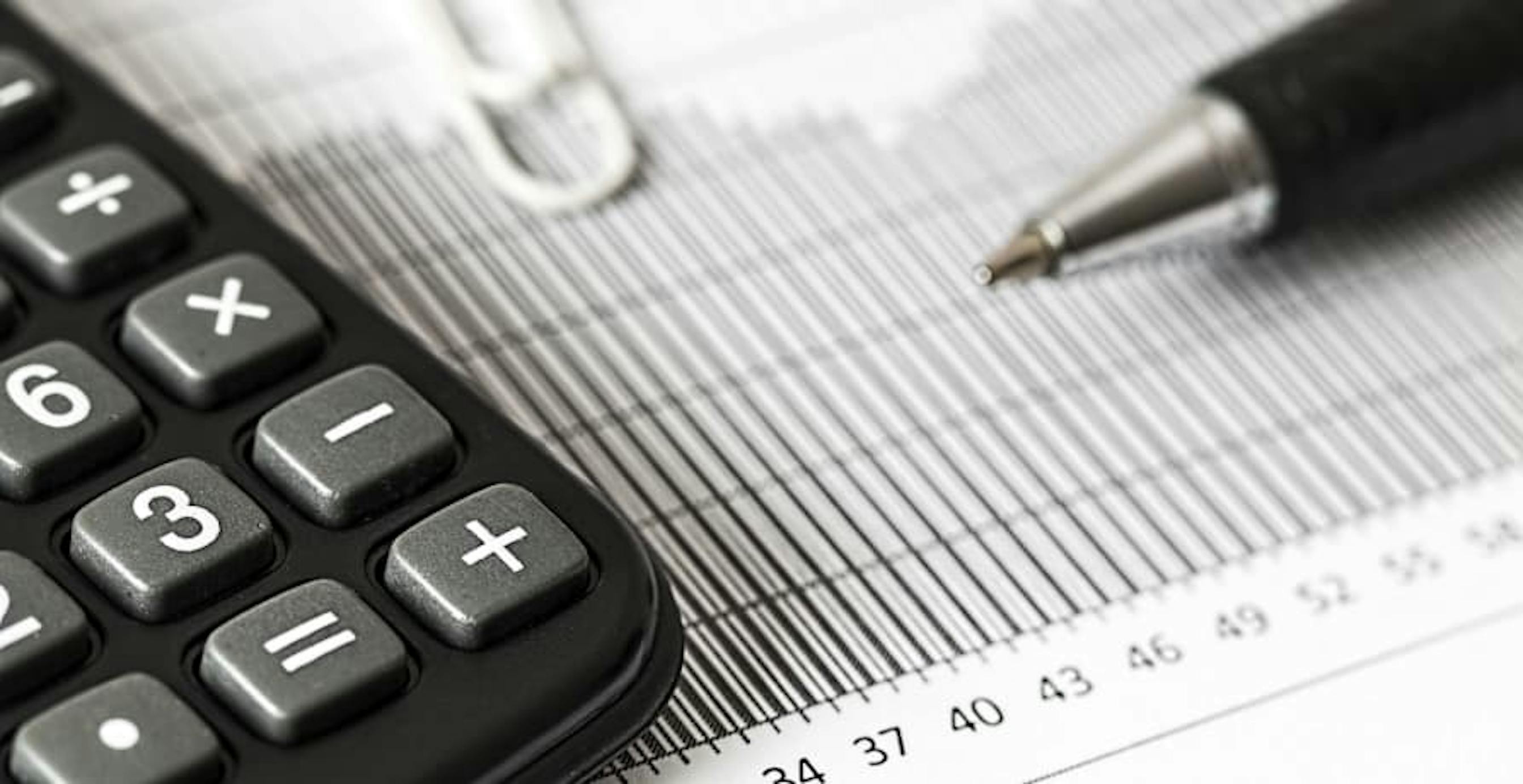 pen, paperclip, and calculator