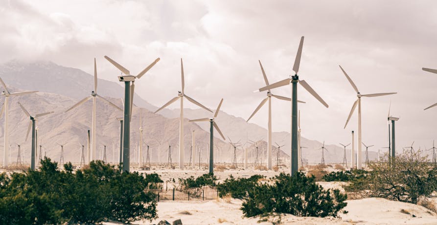 wind turbines against cloudy sky