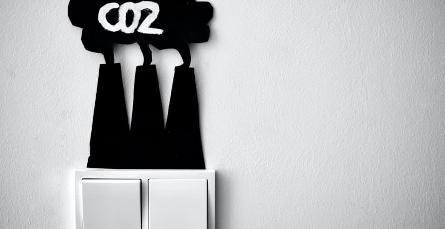 light switchwith black paper cut outs of co2 emissions