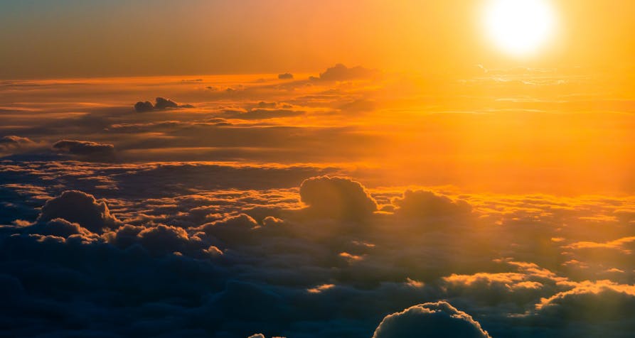 orange sunset above clouds