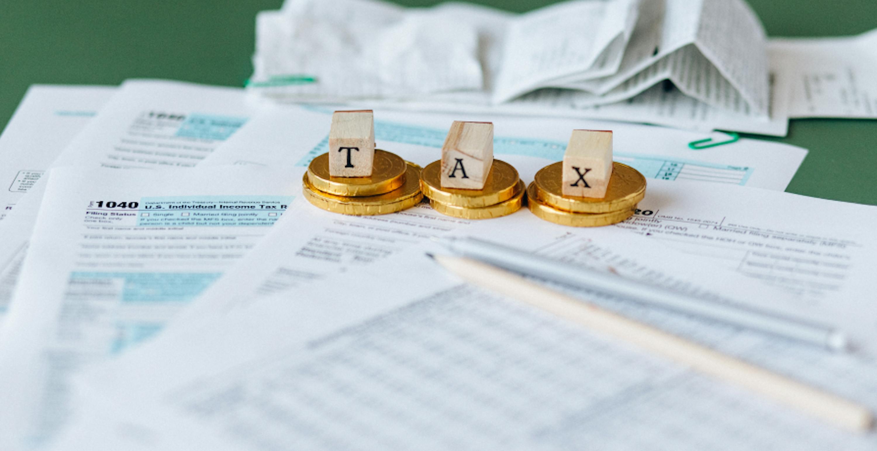 little scrabble cubes spelling out tax on tax papers