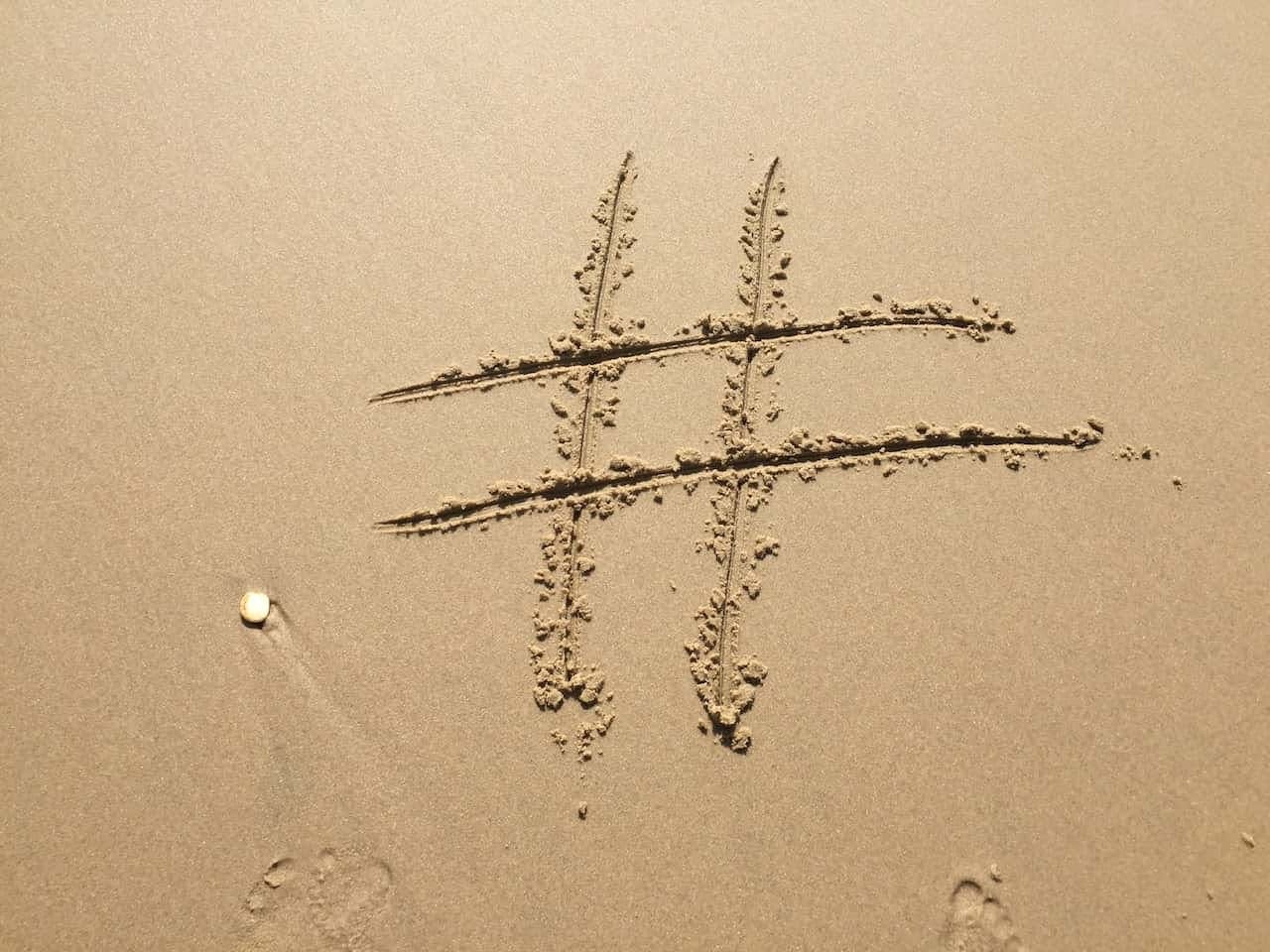 Hashtag sign on sand 