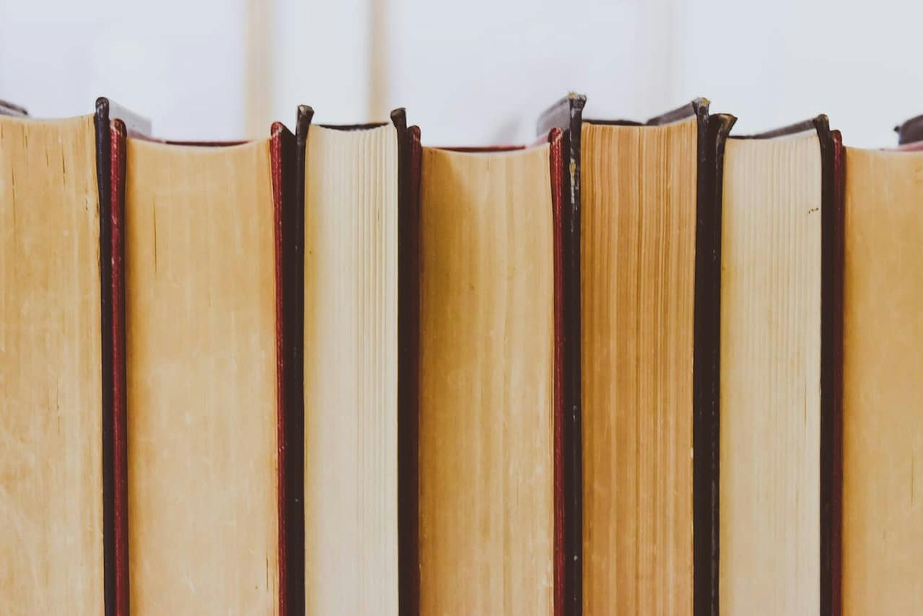 books stacked up on shelf vertical