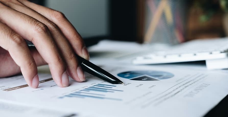 person looking over graphs