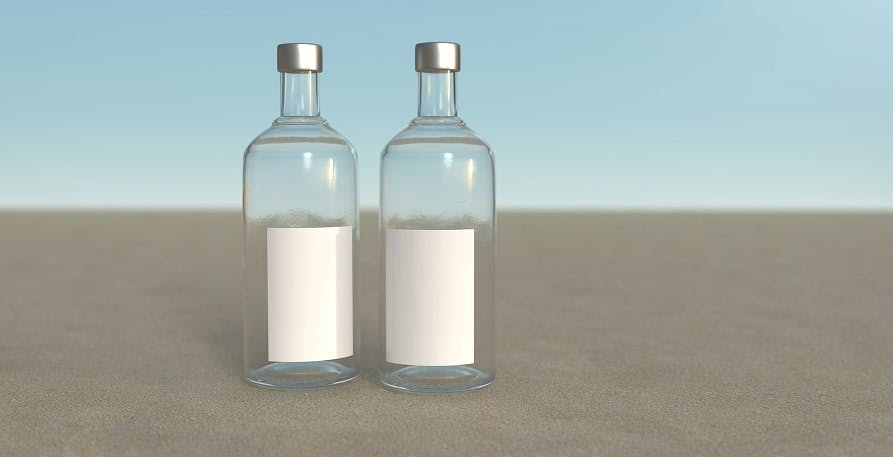 plastic water bottles on beach with light blue sky