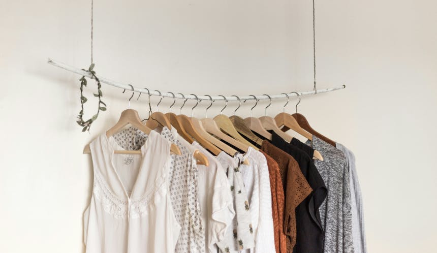 sustainable and minimalist clothes on white rack