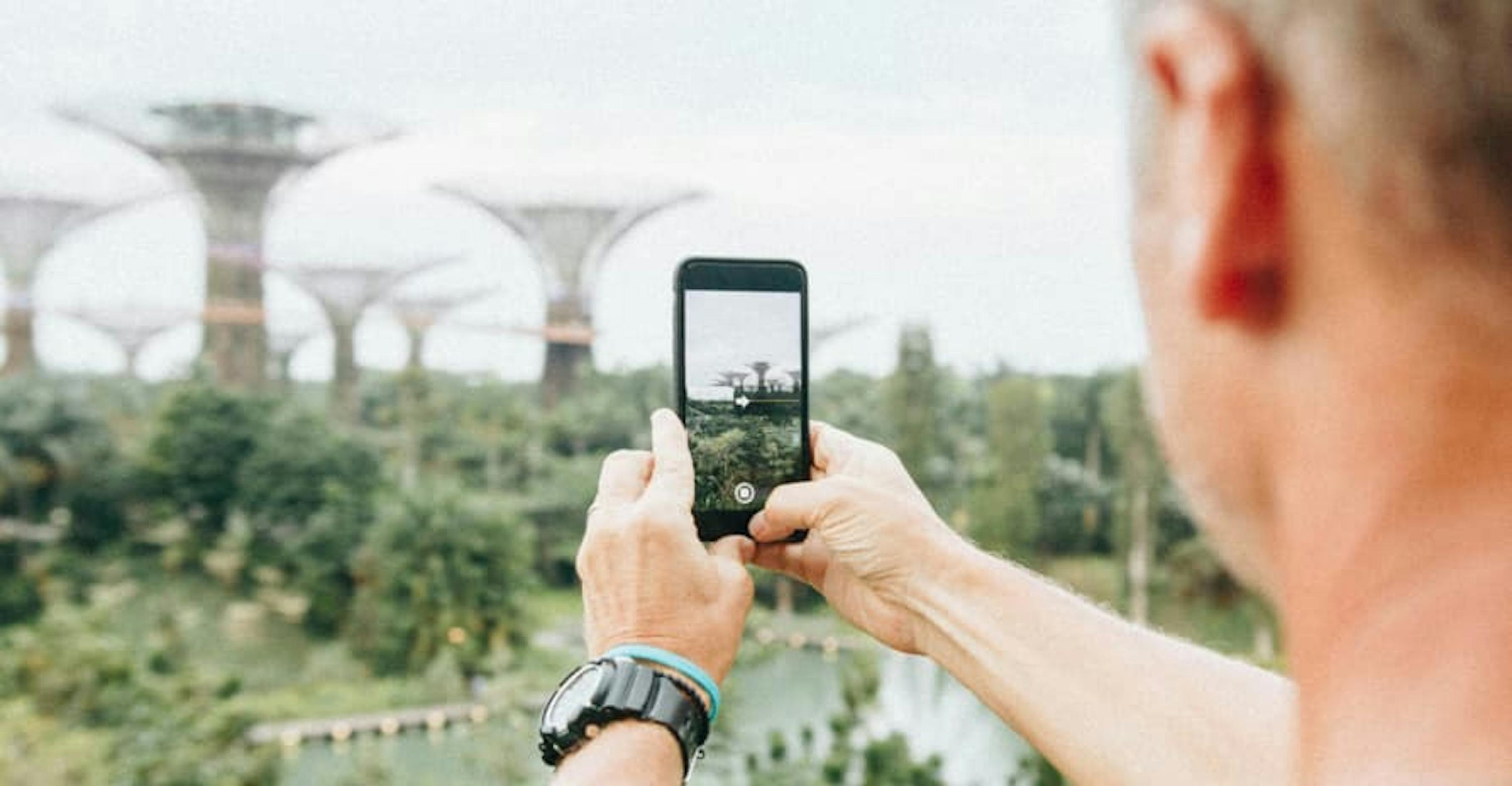 guy taking picture on his smartphone