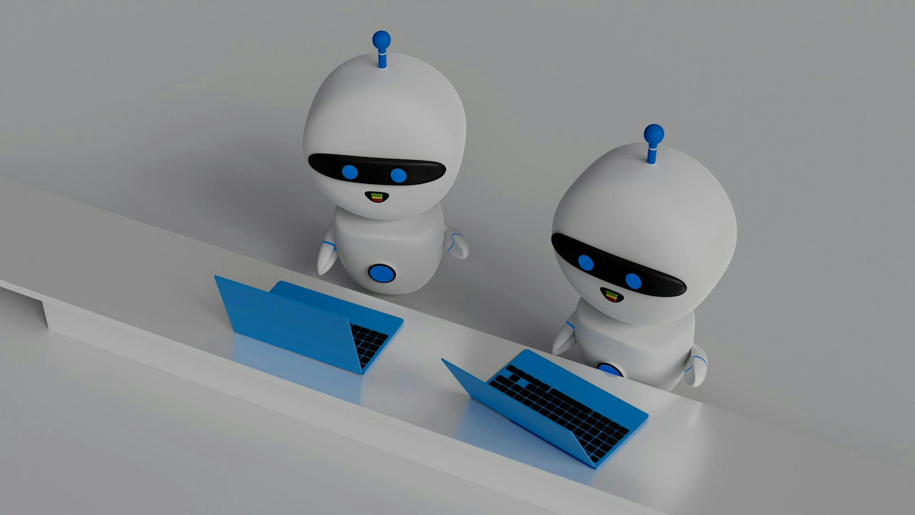 robots in front of their laptops