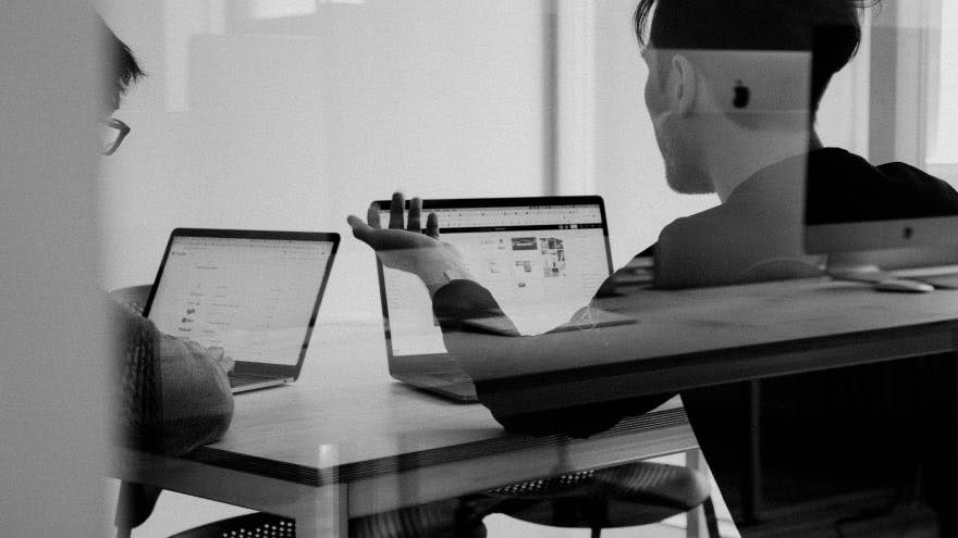 people in room with laptops black and white photo