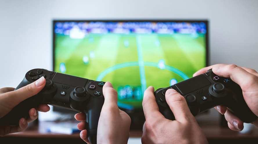 two black game controllers sports game on tv green field