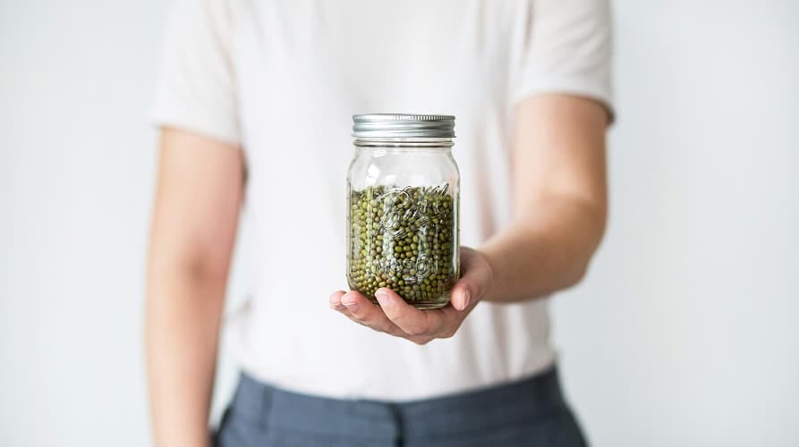 person holding a reusable jar for dried pantry goods