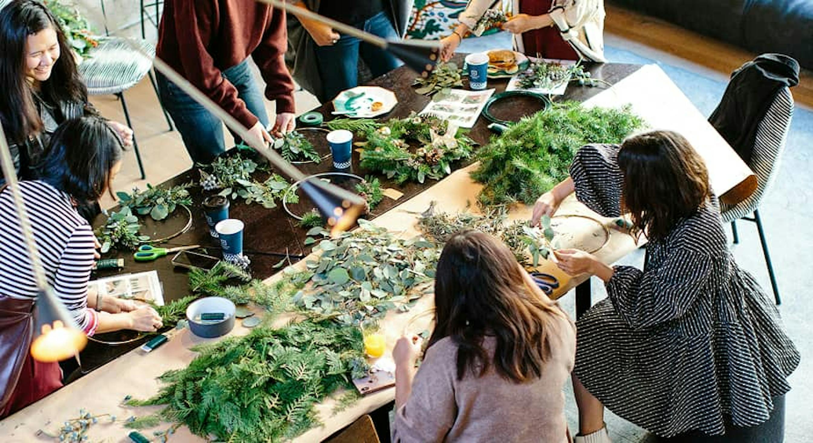 people with greenery at table