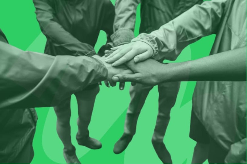 people putting hands together as a team