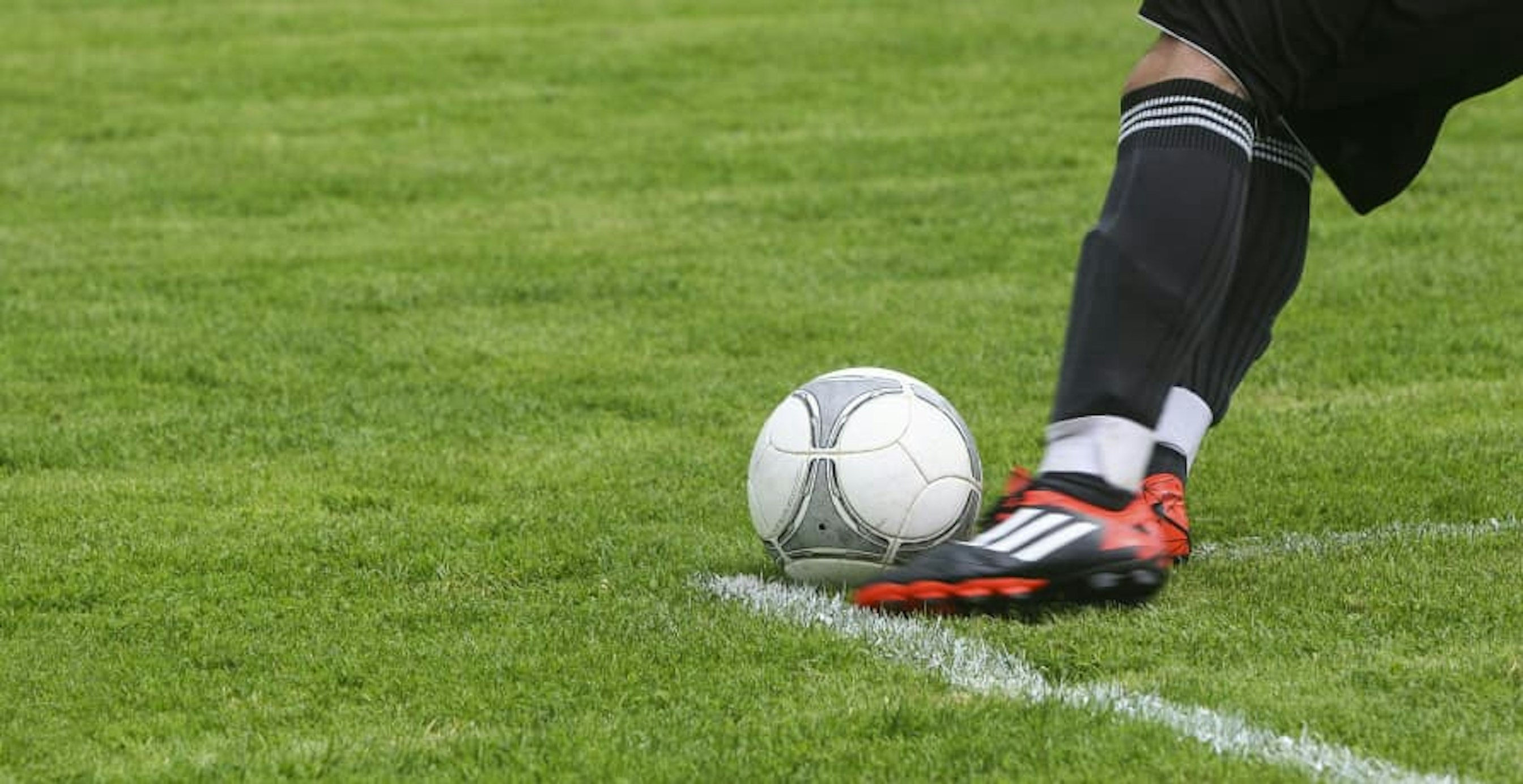 footballer kicking a ball