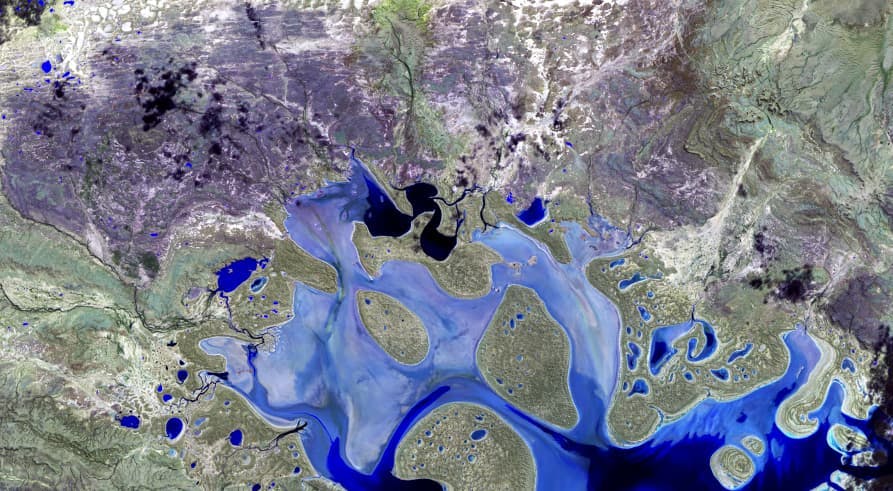 view of water and land from space satellite