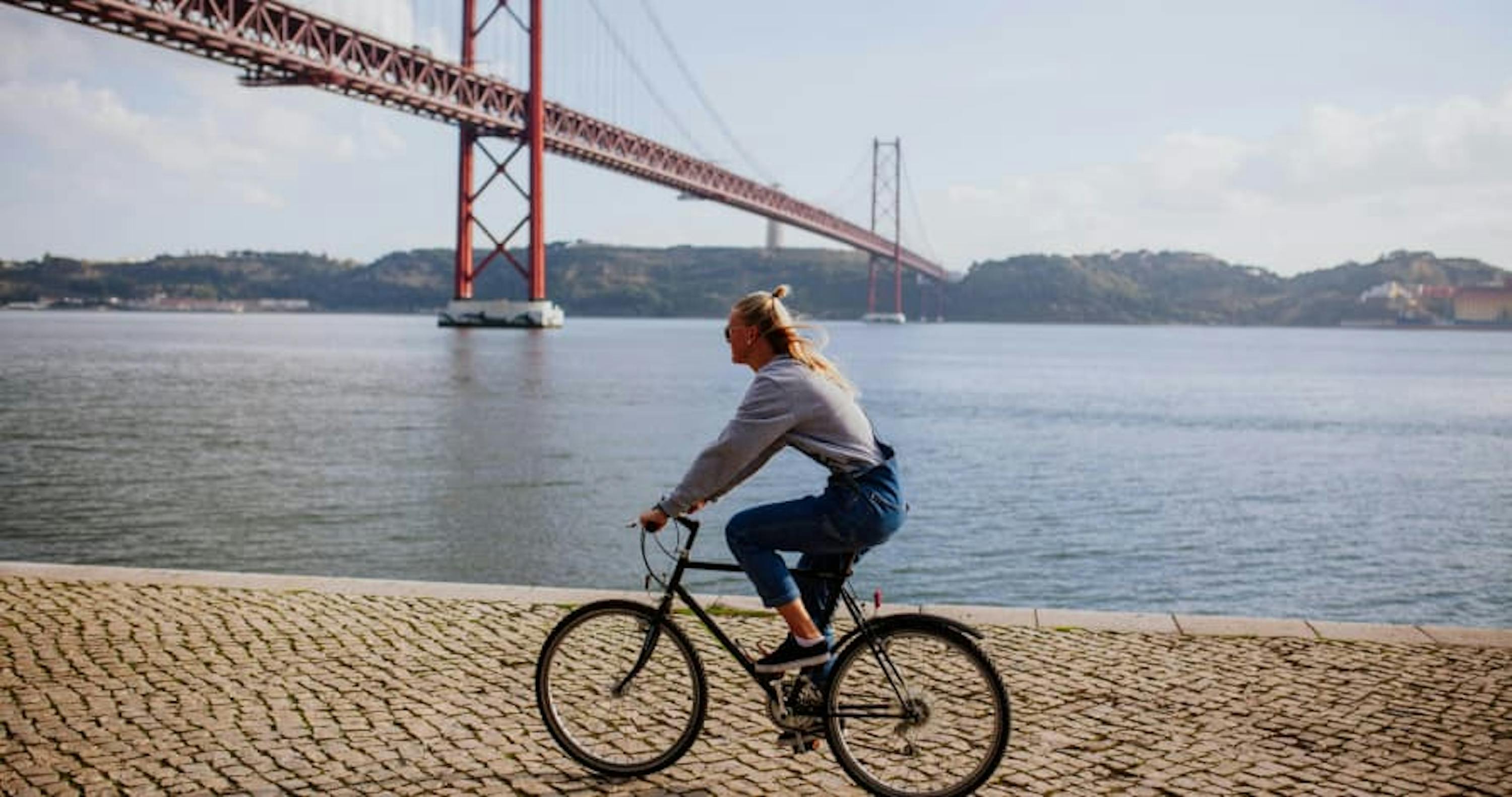 person biking underneath a bridge