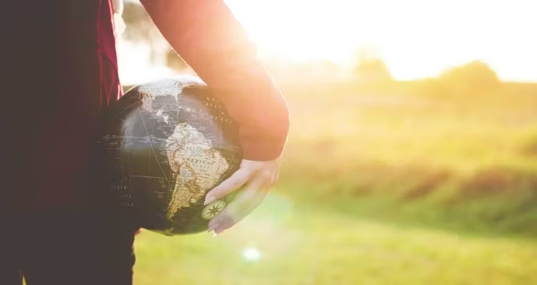 person holding a globe