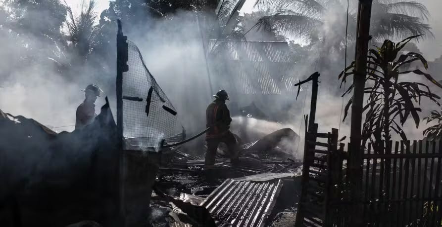 people in destroyed costal house dark clouds