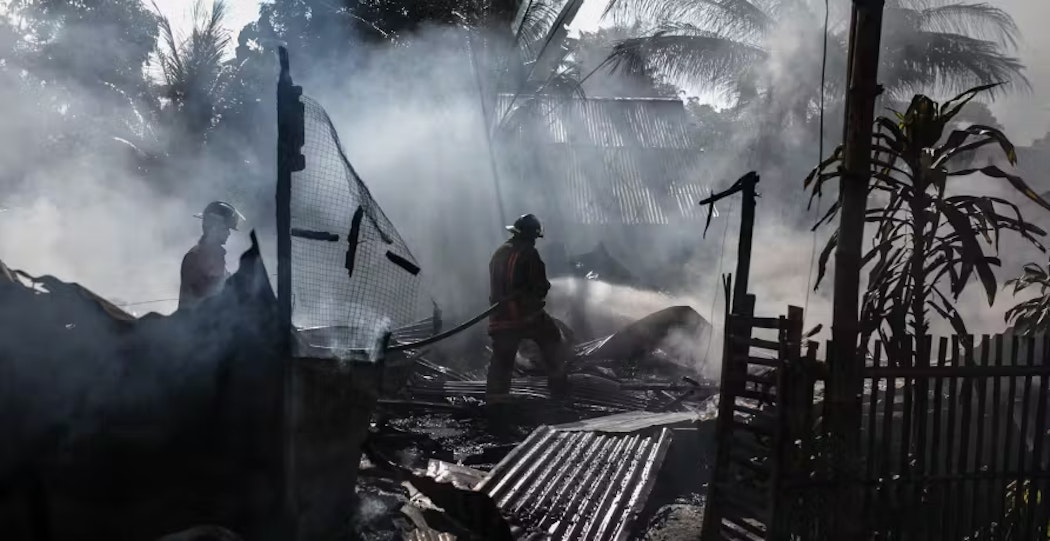 people in destroyed costal house dark clouds