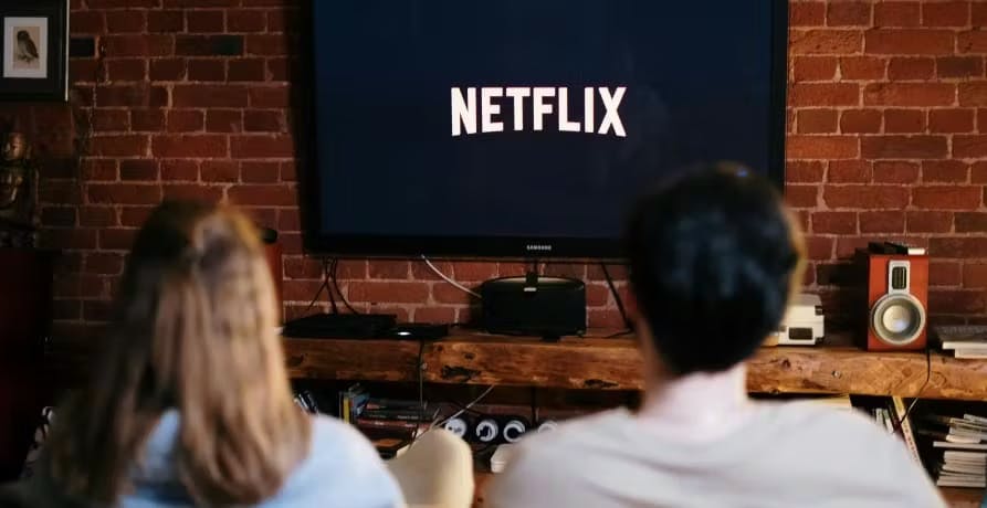 man and woman watching Netflix on a sofa