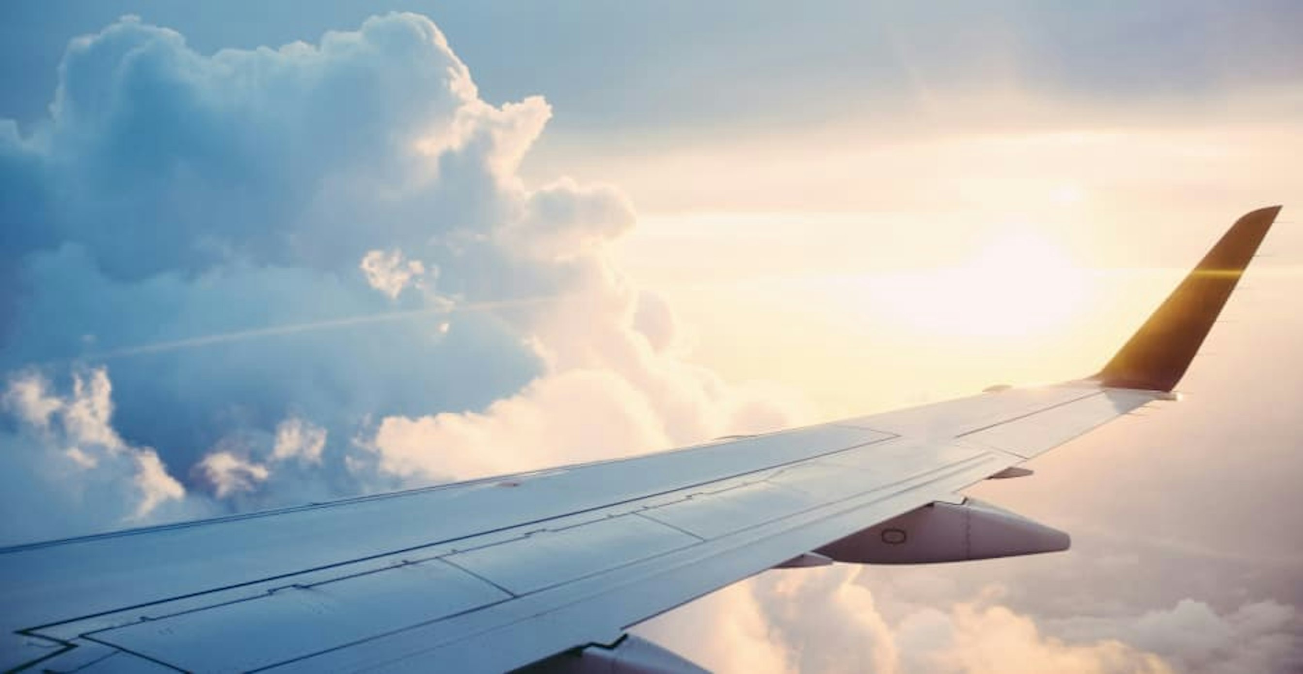 view from plane in sky with sun