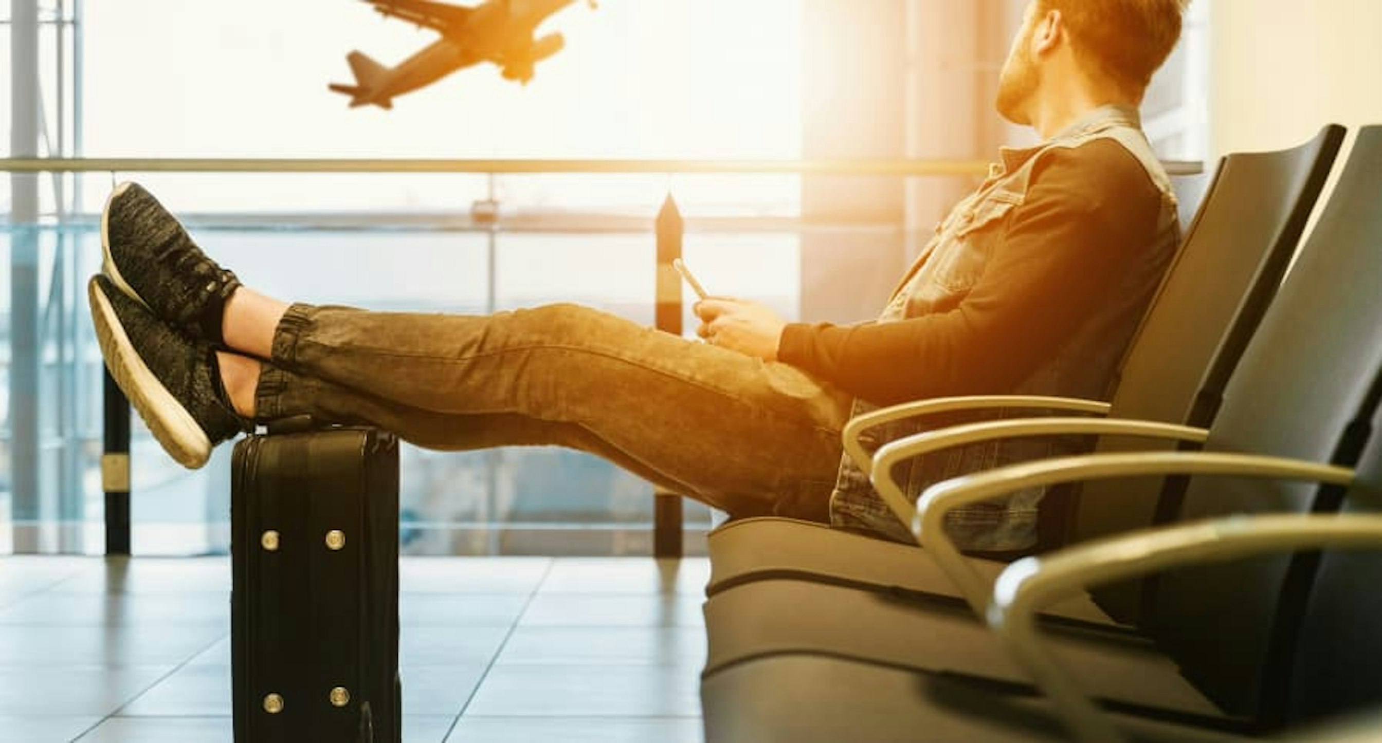 person watching flight take off from the gate
