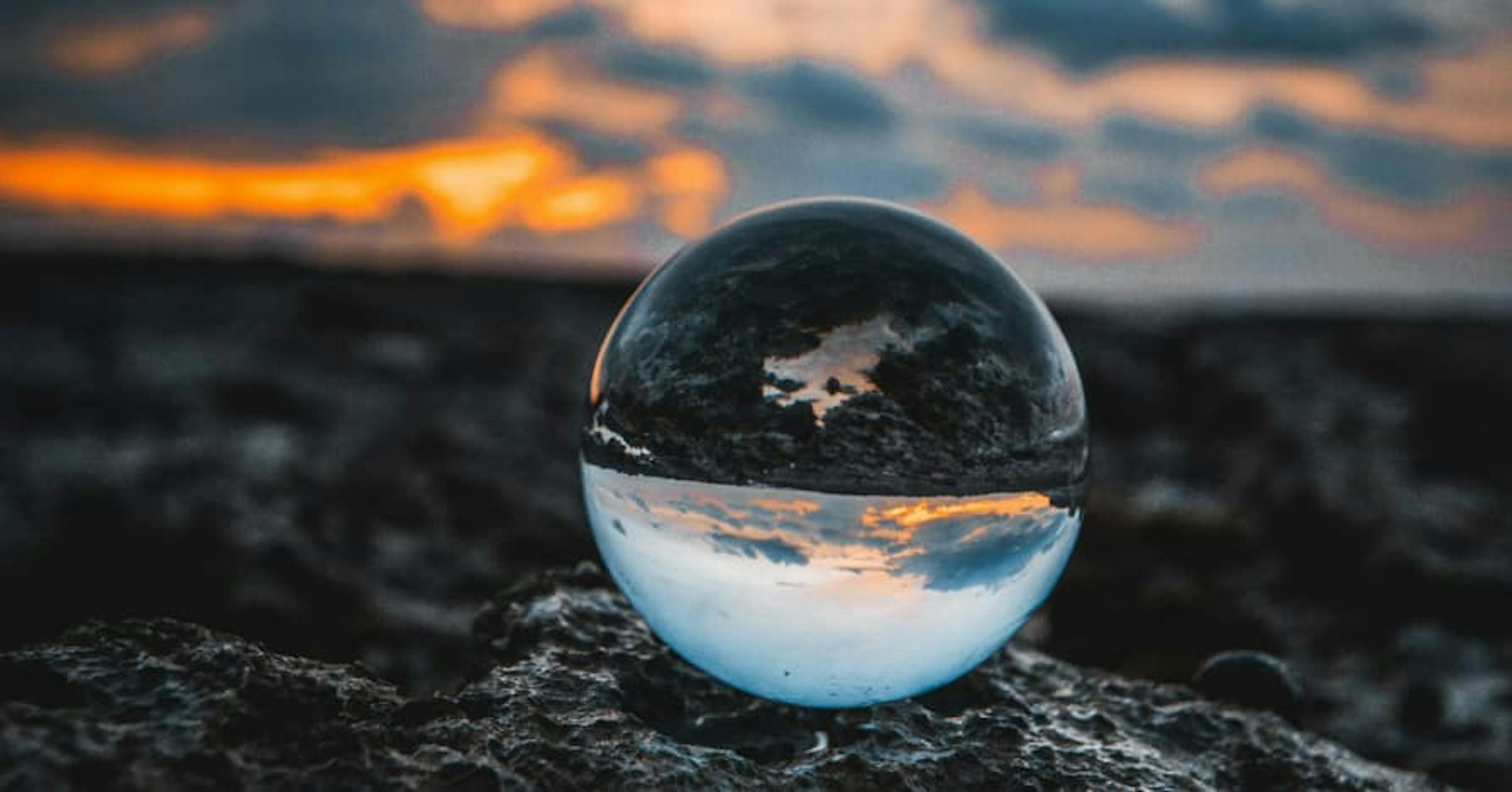 marble on rocky earth against sunset