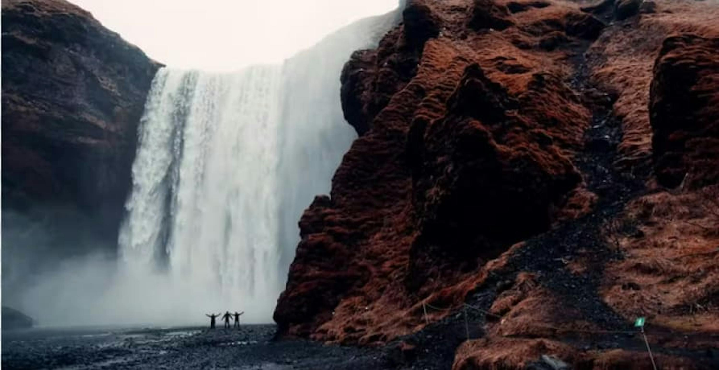 waterfall with red cliffs