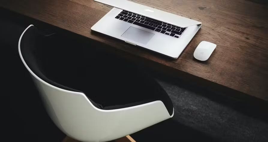 white chair at desk with laptop