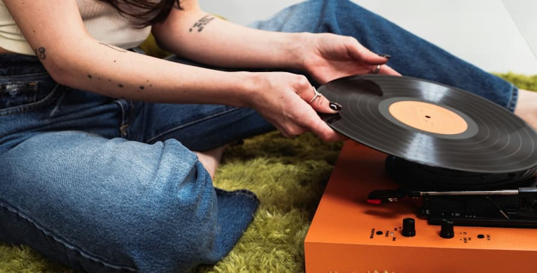 person with a vinyl record player