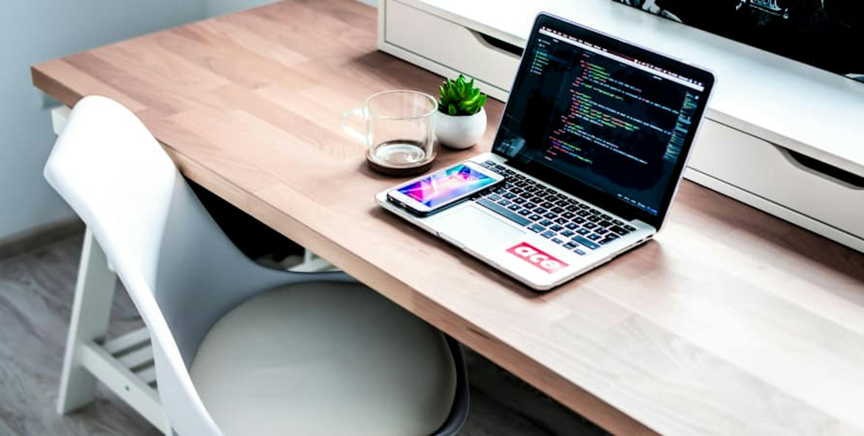 laptop with coding open on bench