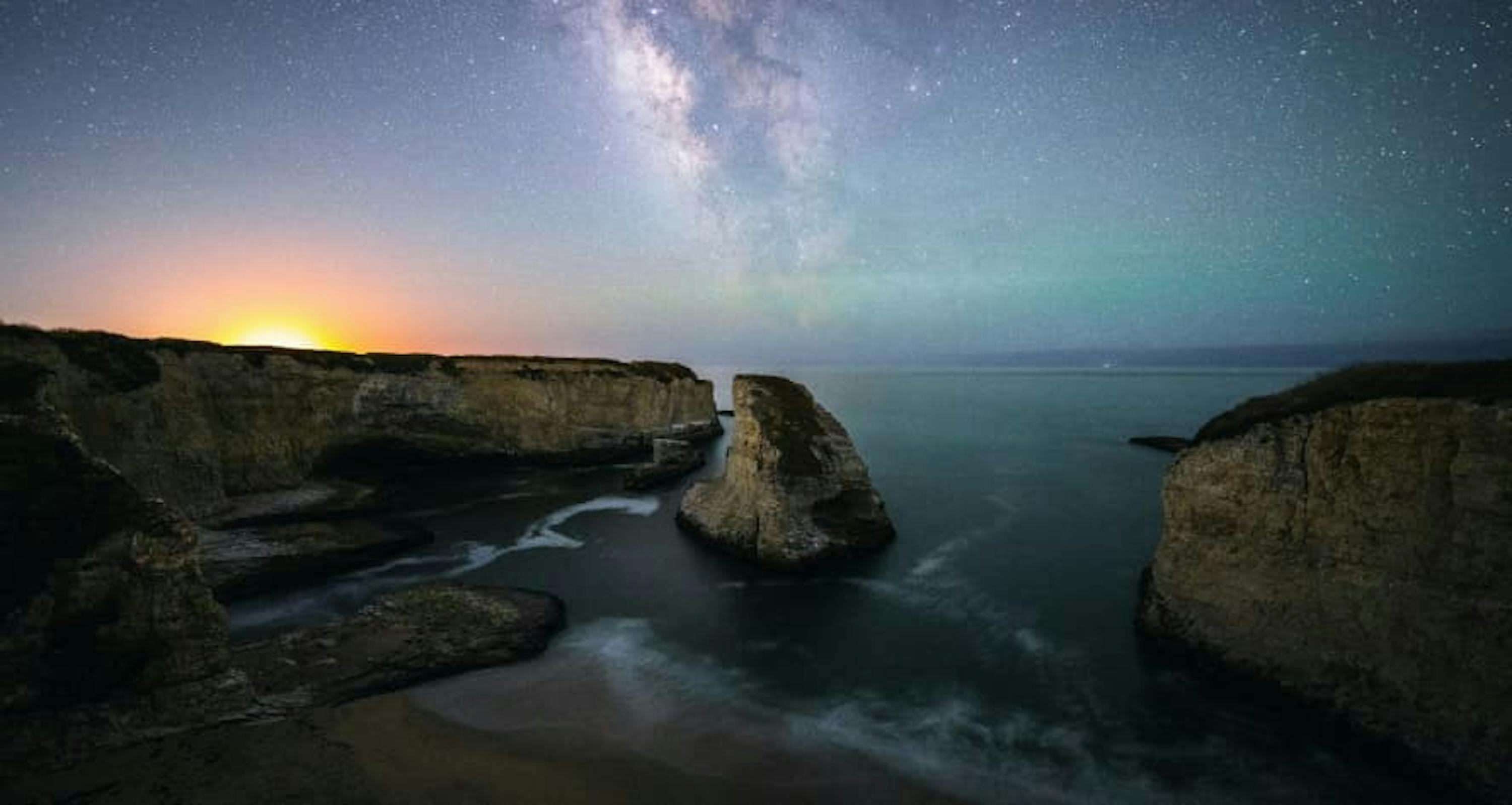 cliffs water over sunset